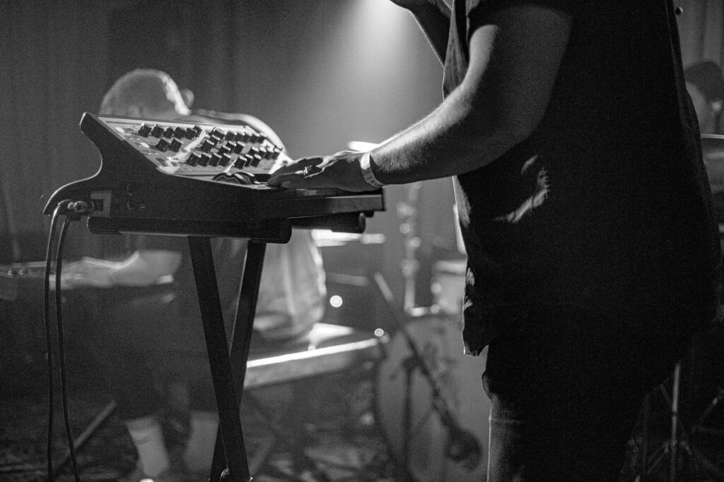 Man Playing Music in Front of Synth